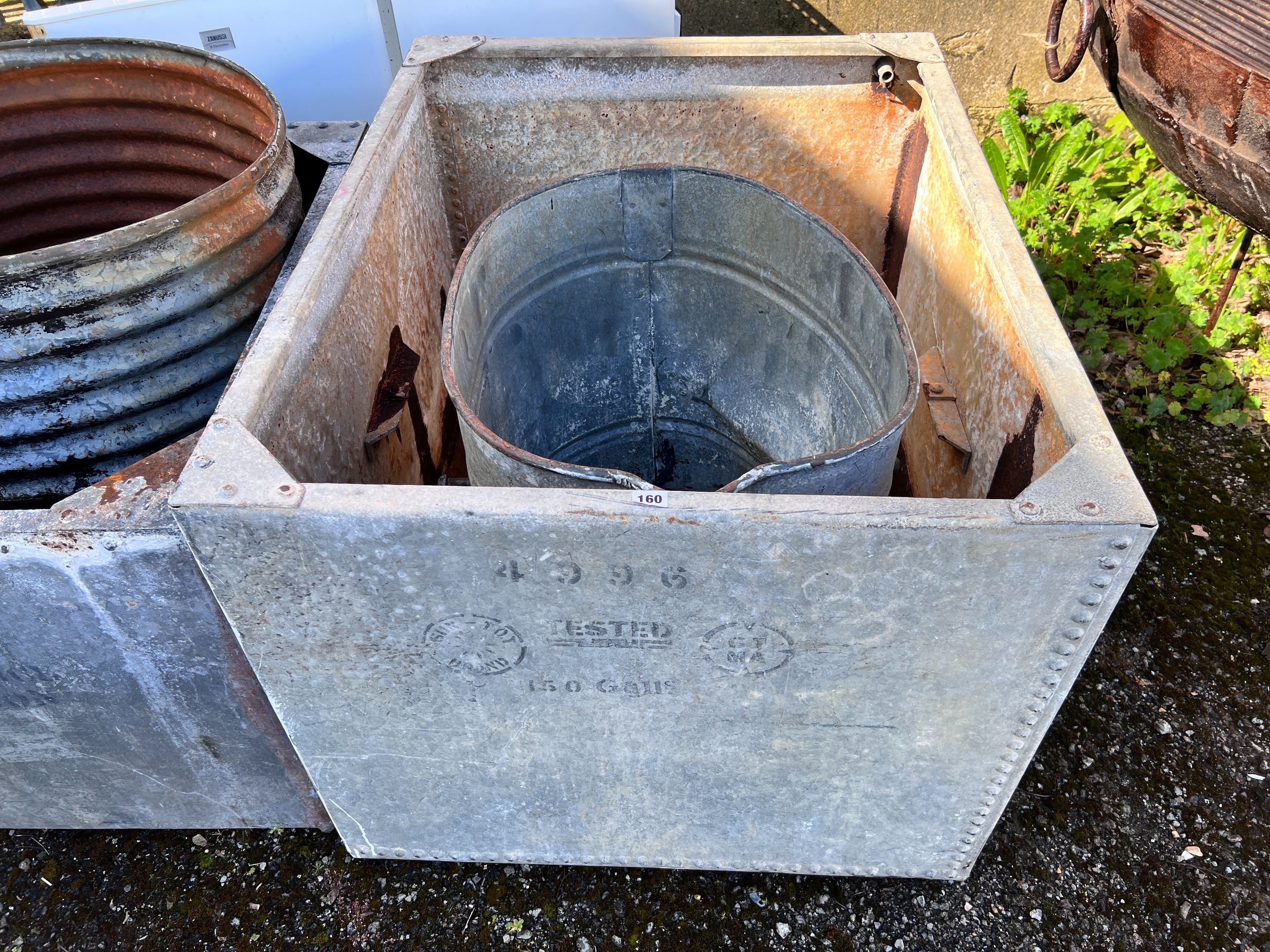 A large rectangular galvanised tank, width 107cm, depth 84cm, height 72cm together with an oval galvanised tank *Please note the sale commences at 9am.